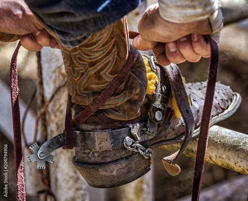 A rider does final prep before seeking the elusive eight seconds staying attached to an unhappy bull.
