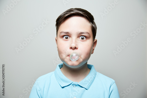 kid blowing bubble gum