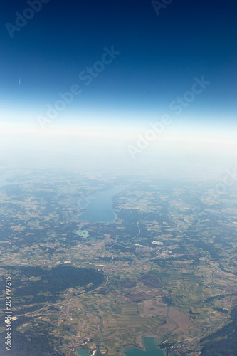 View from the airplane to the sky above the Alps mountains. Blue sky with clouds. Background. © A_Skorobogatova