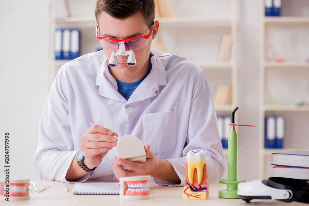 Dentist working teeth implant in medical lab Dentist working teeth implant in medical lab