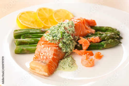 Plate with tasty fish and asparagus, closeup