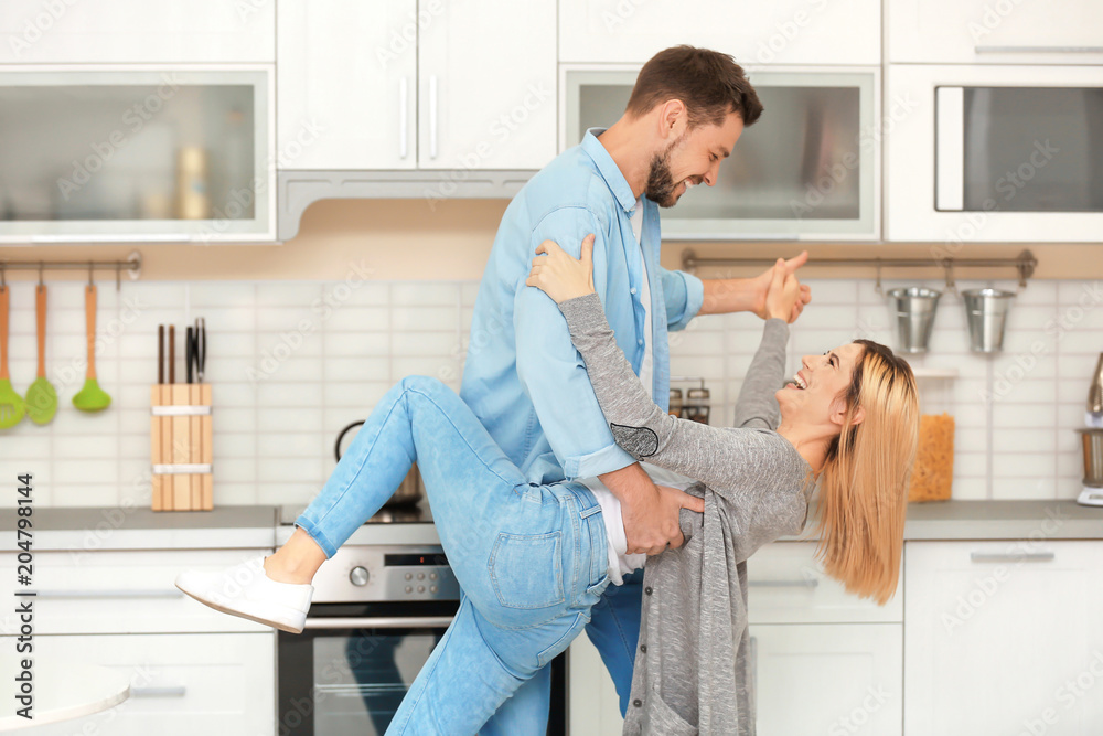 Happy couple dancing in kitchen Happy couple dancing in kitchen