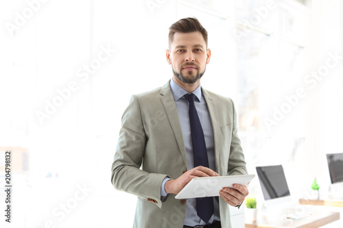 Male lawyer working with tablet in office