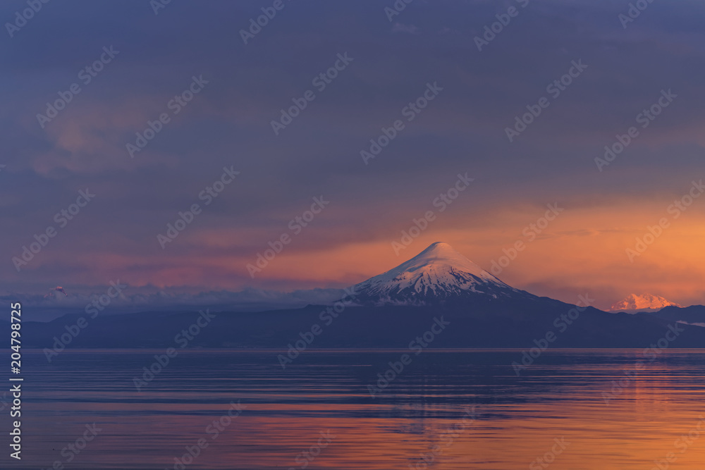 Sunset in the south of Chile, with a view of the Osorno Volcano and over the Llanquihue Lake, its silhouette is reflected