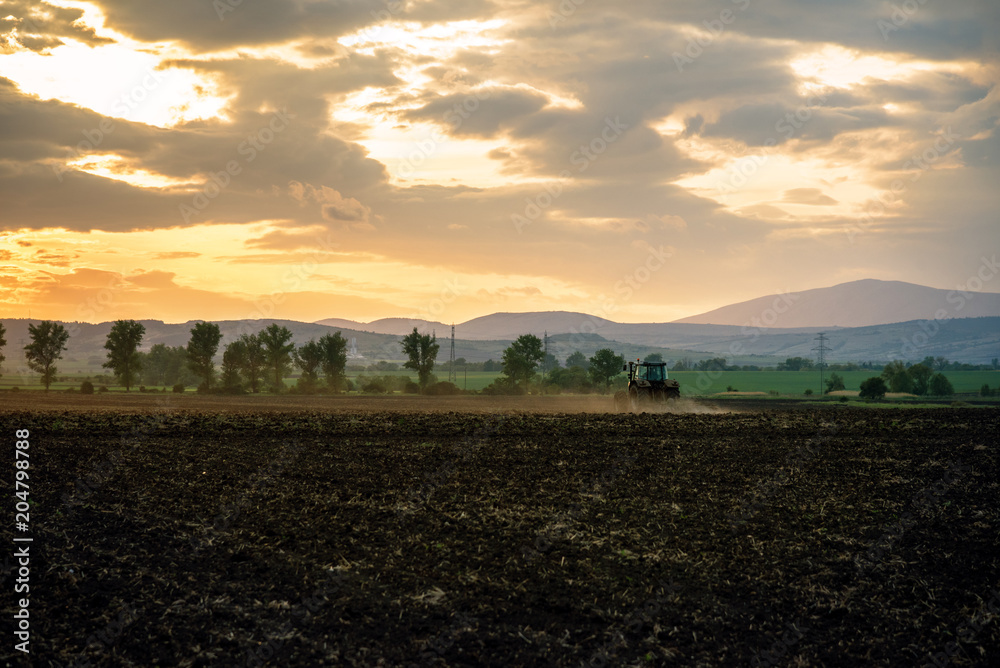 Tractor plowing fields.