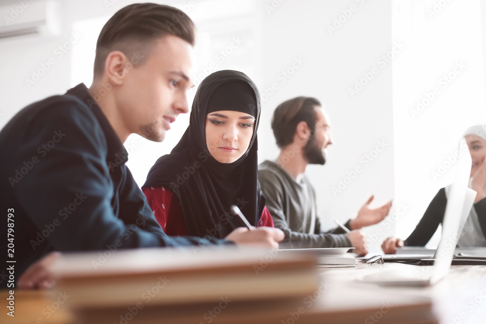Muslim students with their classmates in library Muslim students with their classmates in library