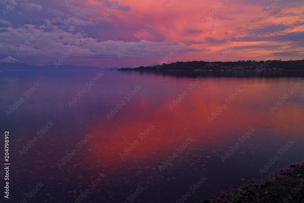 Obraz premium Frame of a time lapse - Sunset in Frutillar overlooking Lake Llanquihue and the Osorno and Calbuco volcanoes