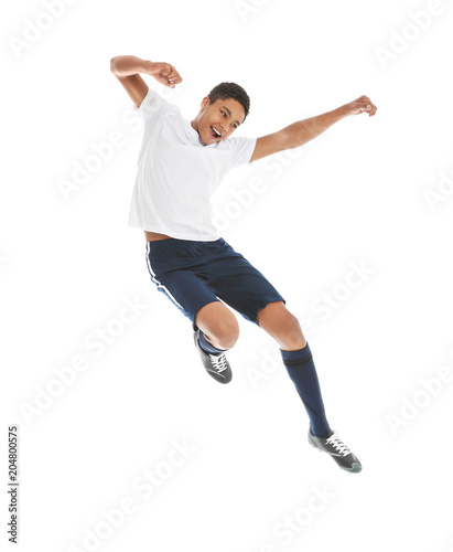 Teenage African-American boy playing football on white background © New Africa