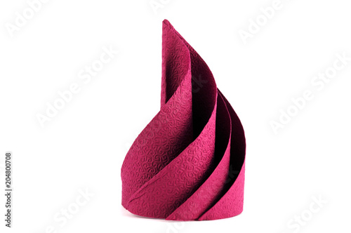 A paper napkin arranged in the form of a spiral triangle.