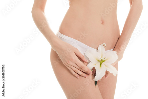 Young woman with flower showing smooth silky skin after epilation on white background