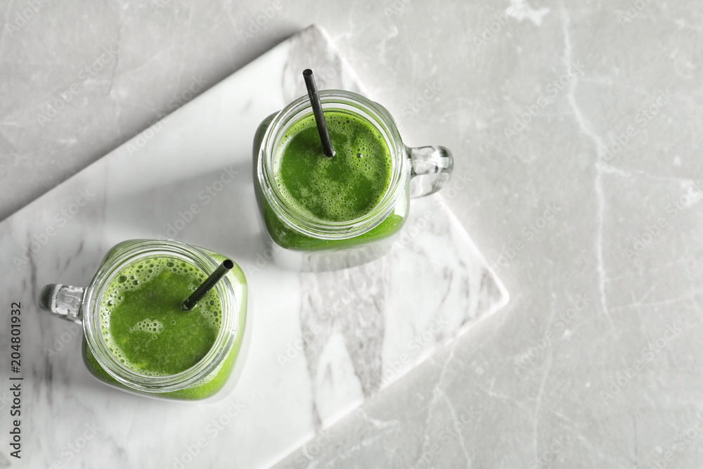 Mason jars with delicious detox juice on table, top view Mason jars with delicious detox juice on table, top view