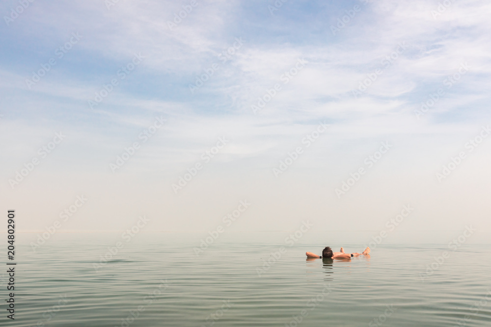 Man floating on his back at the Dead Sea in Israel