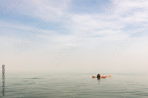 Man floating on his back at the Dead Sea in Israel © oleksandr.info