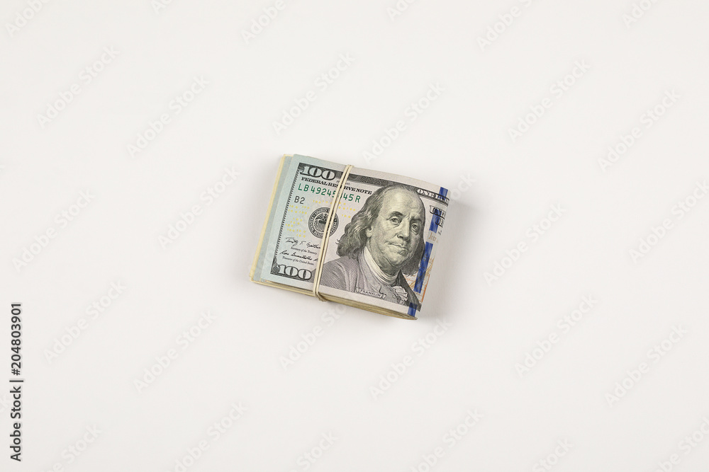 Stack of USA 100 dollars isolated on white background. Stack of USA 100 dollars isolated on white background.