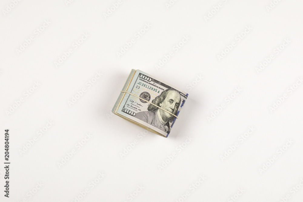 Stack of USA 100 dollars isolated on white background. Stack of USA 100 dollars isolated on white background.