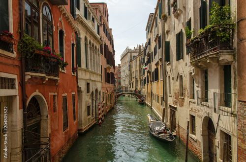 View of a canal of Venice with some boats and a sunny light, Italy © Jeremy