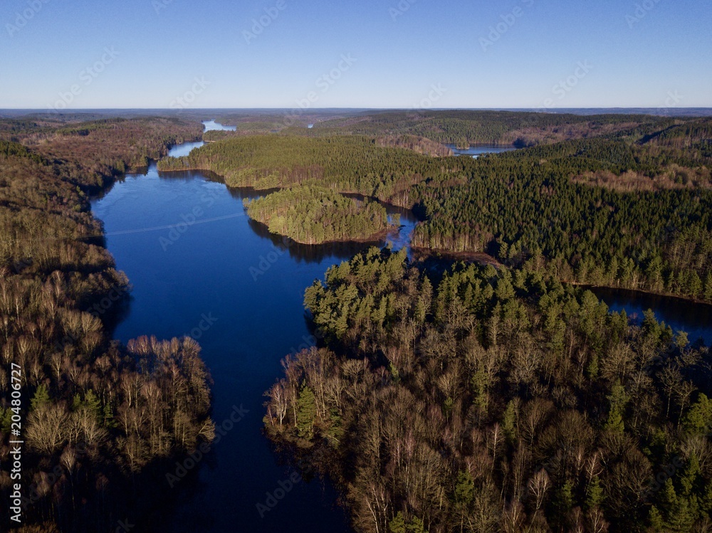 Drone view over lake and forest in Bökestad in Sweden