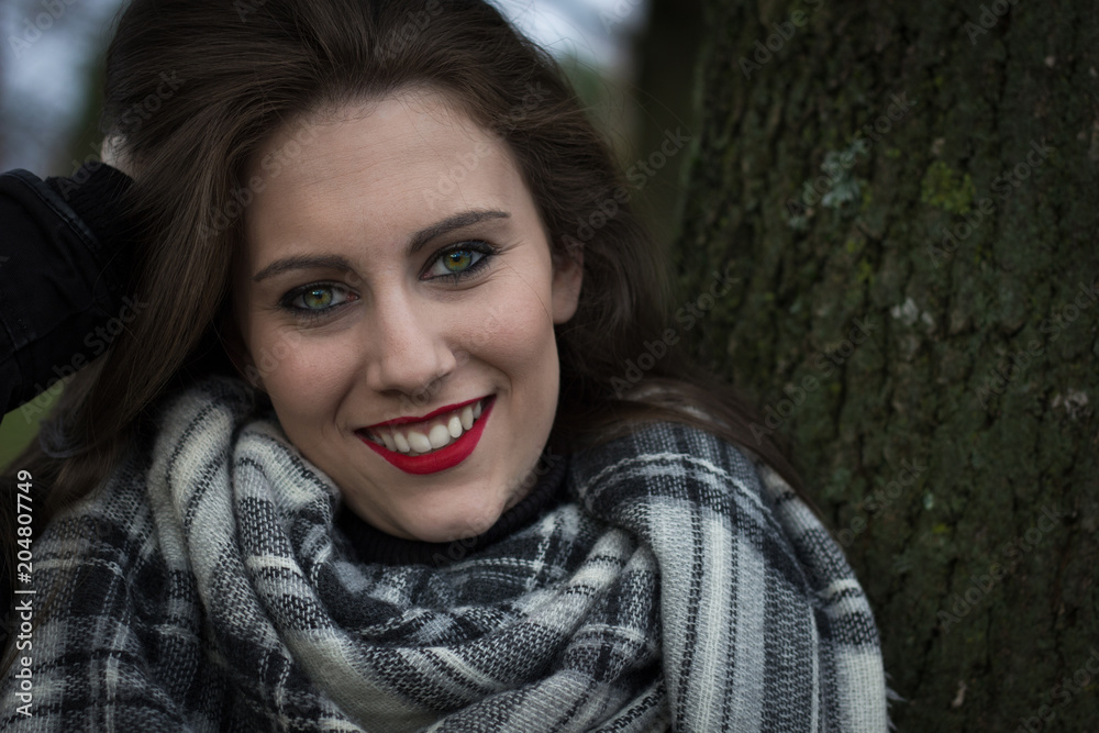 Beautiful close up of smiling attractive girl with amazing green eyes. Portrait of pretty young brunette woman with long hair and makeup, outdoors Beautiful close up of smiling attractive girl with amazing green eyes. Portrait of pretty young brunette woman with long hair and makeup, outdoors