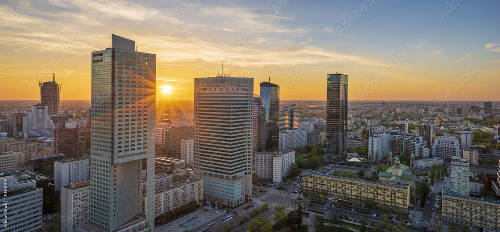 modern skyscrapers in the center of the Polish capital, Warsaw. Sunset sky. - obrazy, fototapety, plakaty 