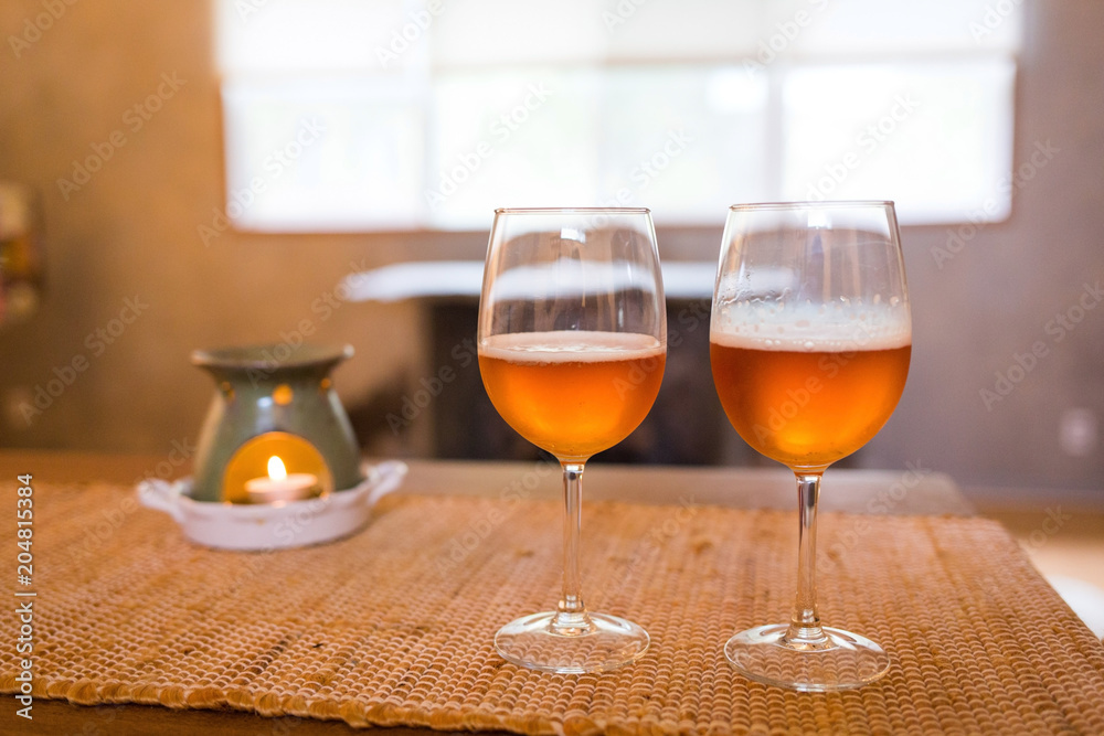 Beer glasses with aroma lamp romantic time at fireplace Beer glasses with aroma lamp romantic time at fireplace