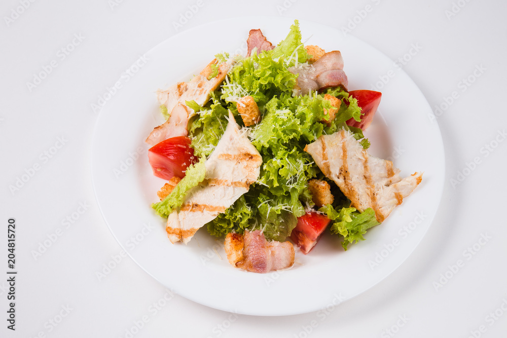 salad with bacon, tomatoes and croutons on a white plate salad with bacon, tomatoes and croutons on a white plate