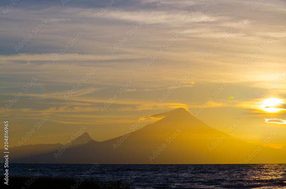 Sunrise in Lake Llanquihue and in the city of the same name, with the Osorno and Puntiagudo volcanoes at the background, southern Chile