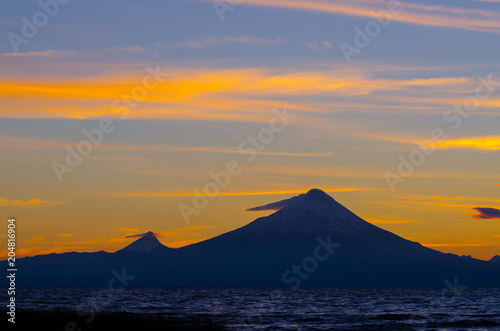 Sunrise in Lake Llanquihue and in the city of the same name, with the Osorno and Puntiagudo volcanoes at the background, southern Chile