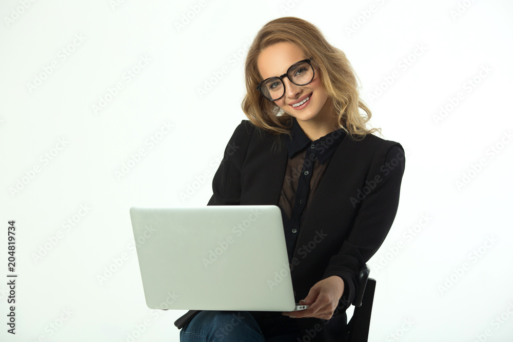 beautiful young girl with glasses in a black suit with a laptop on a white background beautiful young girl with glasses in a black suit with a laptop on a white background