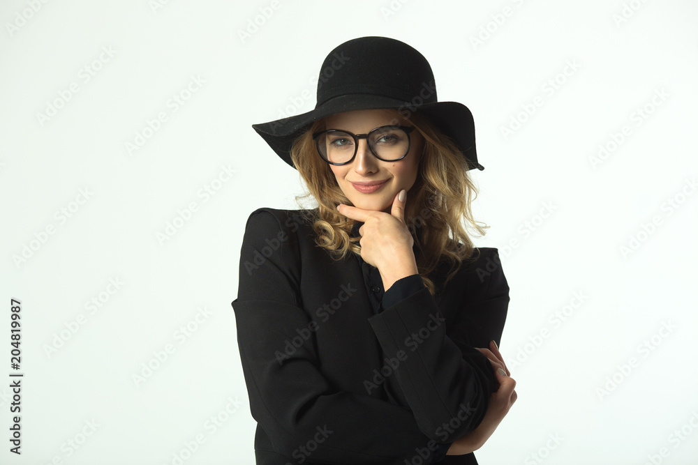 beautiful young girl with glasses and hat, wearing a black jacket on a white background beautiful young girl with glasses and hat, wearing a black jacket on a white background