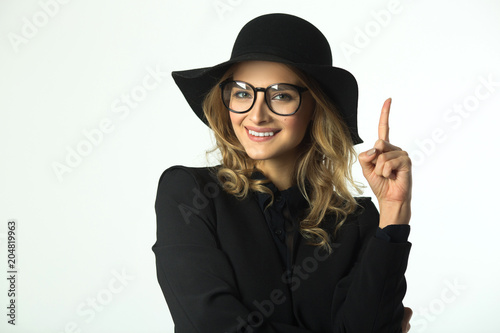 beautiful young girl in a hat on a white background with a smile on her face
