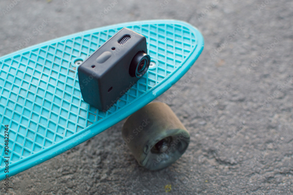 Side view of the action camera in silicon case laying on the blue plastic  penny skateboard. Front view. The concept of city travelling, vlogging,  modern lifestyle Stock Photo | Adobe Stock