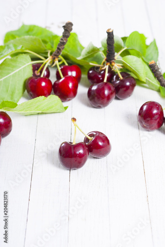 Cherry on white wooden table background