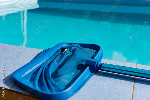 Close up of net cleaner on pool tile