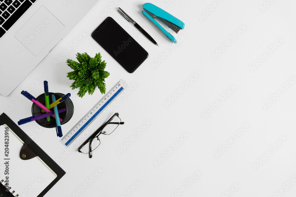 Office supplies on white office desk. Minimal simplicity flat lay with copy space.