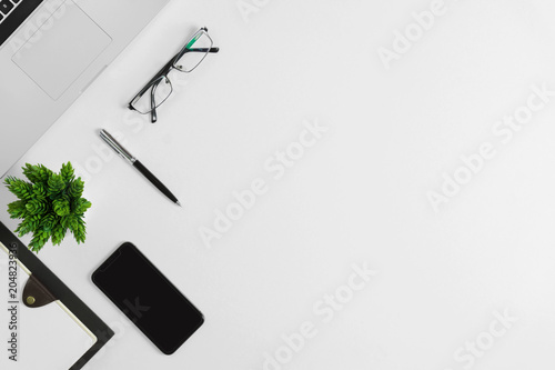 Office supplies on white office desk. Minimal simplicity flat lay with copy space.