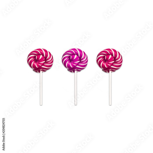 Lollipops Flat lay Minimal concept Three classic round lollipops are lying in a row on white background Trendy photo mockup for banner, poster, web