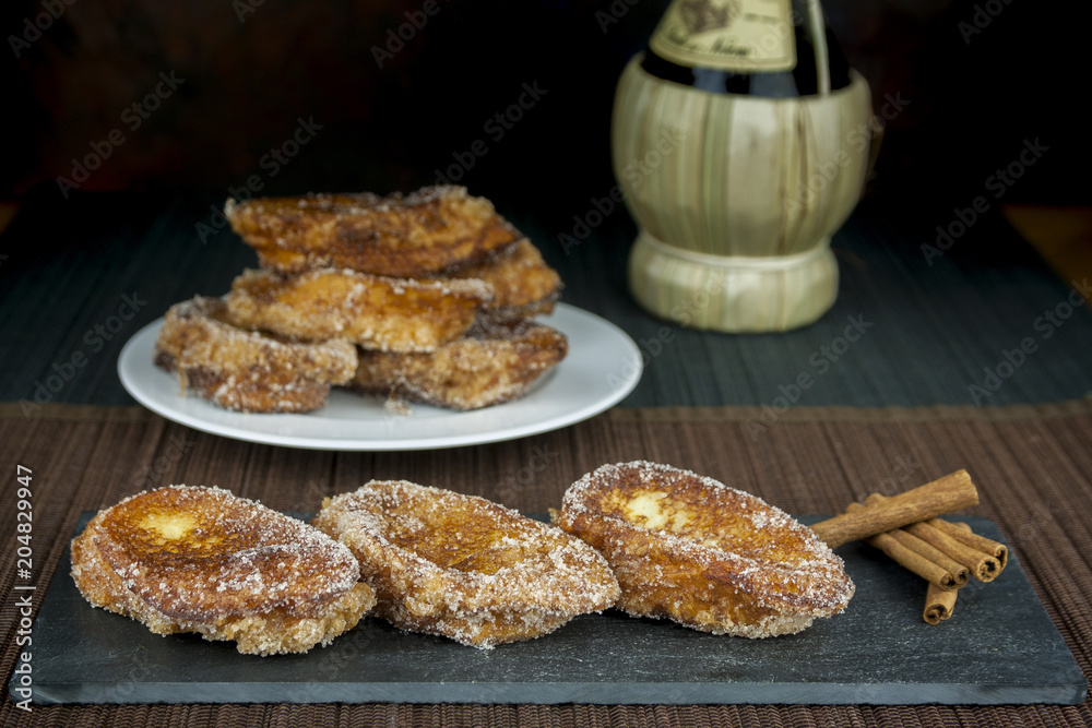 Three traditional Spanish torrijas with cinnamon