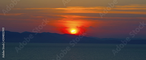 beautiful fiery sunset over the sea © Юлия Моисеенко