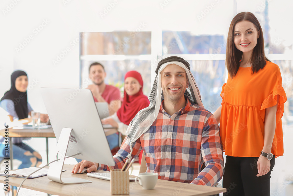 Muslim businessman with coworker in office Muslim businessman with coworker in office