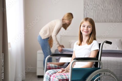 Teenage girl in wheelchair ...