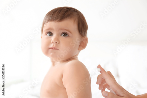 Woman applying body cream o...