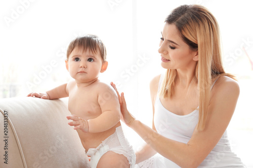 Woman applying body cream o...