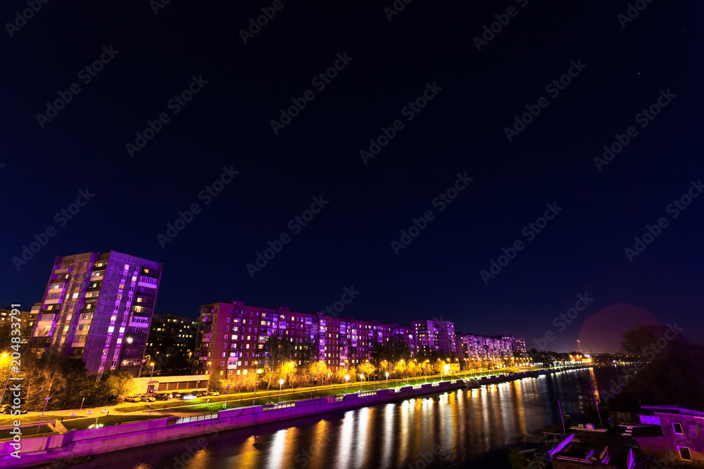 Residential houses near a river with a violet backlight