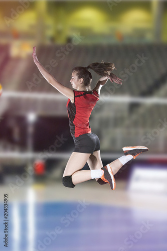 Female volleyball players jumping close-up on vollayball court.