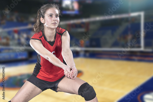 Female professional volleyball player on volleyball court