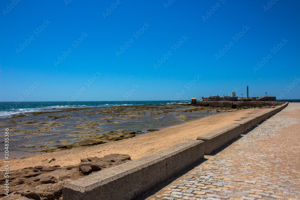 Castle of San Sebastian. A sunny day on the beach of Cadiz. Andalusia, Spain.