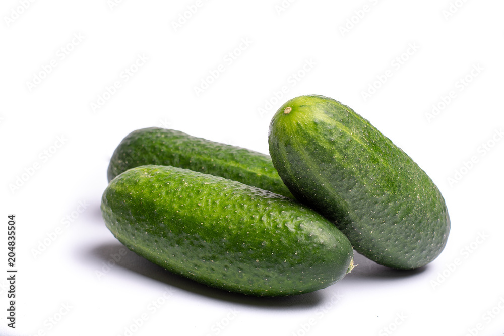 Fresh small green cucumbers close up copy space isolated on white background Fresh small green cucumbers close up copy space isolated on white background