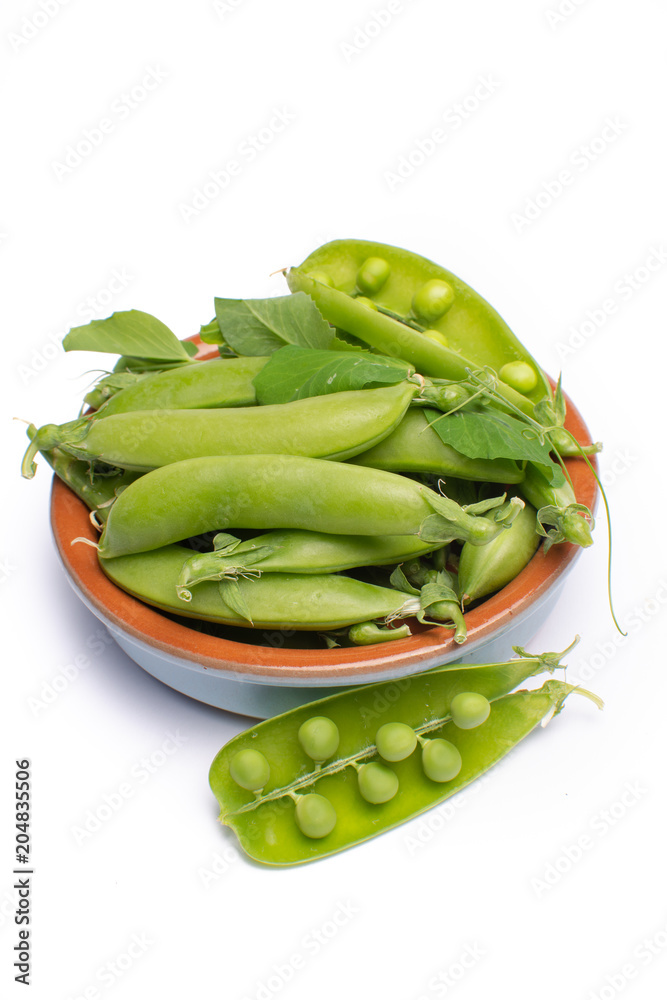 Fresh green ripe sugar snaps, sweet peas in bowl copy space close up isolated on white background Fresh green ripe sugar snaps, sweet peas in bowl copy space close up isolated on white background