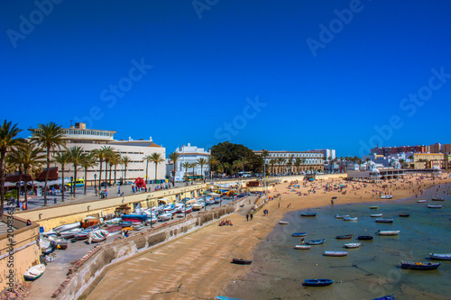 Promenade. A sunny day on the beach of Cadiz. Andalusia  Spain. Picture taken     6 may 2018.