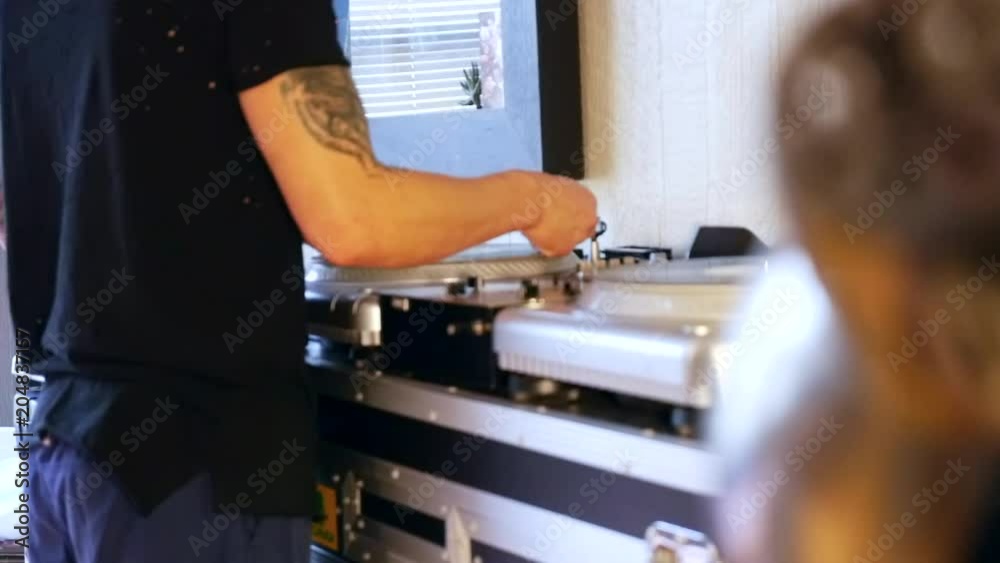 Mix and scratch, hands of a DJ on vinyl and mixer knobs. Close up of hands of DJ plays music mixing and scratching on turntable music equipment. Mix and scratch, hands of a DJ on vinyl and mixer knobs. Close up of hands of DJ plays music mixing and scratching on turntable music equipment.